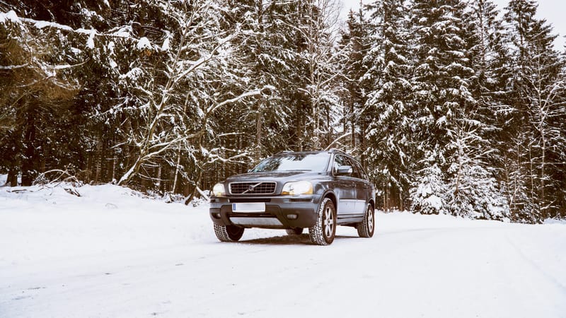 冬日，沃尔沃 XC90 SUV 站在白雪覆盖的森林中
